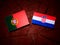 Portuguese flag with Croatian flag on a tree stump isolated