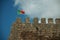 Portuguese flag fluttering on top of tower from Castle