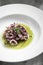 Portuguese traditional fresh seafood marinated squid salad in coriander oil