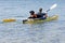 Portuguese Water Dog on Yellow Kayak