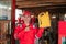 Pose of young mechanic in wearpack uniform and hat standing with finger pointing while carrying oil bottle