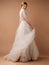 Posh wedding dress. Fashionable bridal gown with tender french lace and beads, long sleeves, weightless tulle skirt.