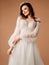 Posh wedding dress. Fashionable bridal gown with tender french lace, long sleeves, tulle skirt. Contemporary design.