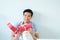 posing asian handsome man smiling with red gift box holding in hand