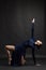 Posing dancer in blue dress over dark background