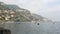 Positano picturesque seascape view from wild stone beach to Tyhrrenian sea, mountains and high rocks with tower on cliff