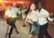 Positive adult pairs enjoying dancing salsa in modern dance studio