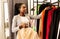 Positive African American Woman Buying Trendy Clothes In Boutique