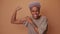 Positive African young woman raises muscular arm shows biceps has powerful look