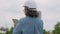 Positive age Asian female architecture in hardhat hold tablet and standing in front of city for inspect building after