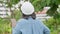 Positive age Asian female architecture in hardhat hold tablet and standing in front of city for inspect building after