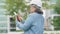 Positive age Asian female architecture in hardhat hold tablet and standing in front of city for inspect building after