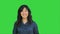 Positive asian businesswoman talking, looking at camera on a Green Screen, Chroma Key