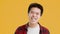 Positive Asian Guy Laughing Looking At Camera On Yellow Background