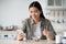 Positive asian woman having breakfast and surfing on social media