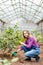 Positive awesome woman is interested in plants