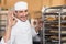 Positive baker checking freshly baked bread