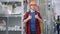 Positive bearded young Caucasian man in hard hat looking at camera showing thumbs up standing in hardware store