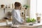 Positive beautiful young red haired woman baking cookies at home