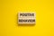 Positive behavior support symbol. Concept words Positive behavior on wooden blocks on a beautiful yellow background. Business,