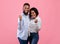 Positive black couple making YES gesture, feeling triumphant, celebrating their success on pink studio background