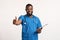 Positive black man doctor showing thumbs up at camera