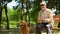 Positive blind man feeding guide dog, sitting in park, nutritious canine food