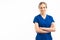 Positive blonde healthcare worker woman in dark blue uniform looking at camera and crossing her arms. Isolated medium