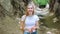 Positive blonde woman making faces in natural loess ravine