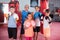 Positive boxer with coach standing near punching bags