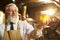 Positive brewer holding beer glass with foam.