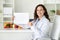 Positive brunette lady doctor dietician showing blank placard