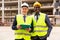 Positive builders standing on construction site