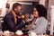 Positive caring man feeding his girlfriend with a cake