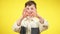 Positive Caucasian boy making heart shape with hands looking at camera smiling. Portrait of confident joyful kid posing