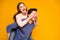 Positive cheerful woman close cover her spouse man eyes hug embrace piggy-back enjoy valentine day celebration wear blue