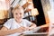 Positive child feeling glad while making notes in front of a laptop