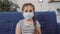 positive child protective in a medical mask pandemic. coronavirus stay home concept. little girl child takes pandemic