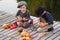 Positive children paint small Halloween pumpkins