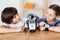 Positive children playing with robot