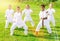 Positive children practicing karate in park