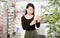 Positive chinese woman near counter chooses antibacterial at in pharmacy