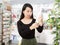 Positive chinese woman near counter chooses antibacterial at in pharmacy