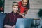 Positive chinese young man and woman reading mail on netbook