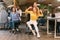 Positive colleagues having fun in office, enjoying office chair race