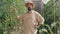 Positive confident male gardener talking looking at camera standing in sunny greenhouse. Portrait of joyful Caucasian