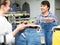 Positive couple buying jeans in shop