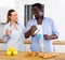 Positive couple having breakfast in kitchen at home