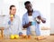 Positive couple having breakfast in kitchen at home