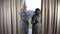 Positive couple, man and woman in bathrobes drink coffee by the window in a hotel room, concept of vacation, travel